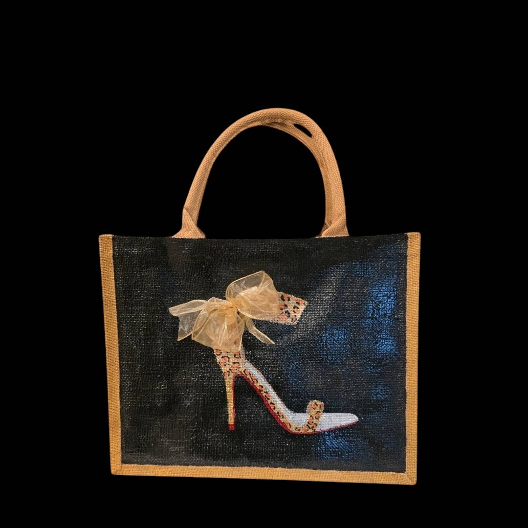 Tan-handled tote with a leopard-print stiletto, sheer bow, red sole, on a dark background with tan edging.